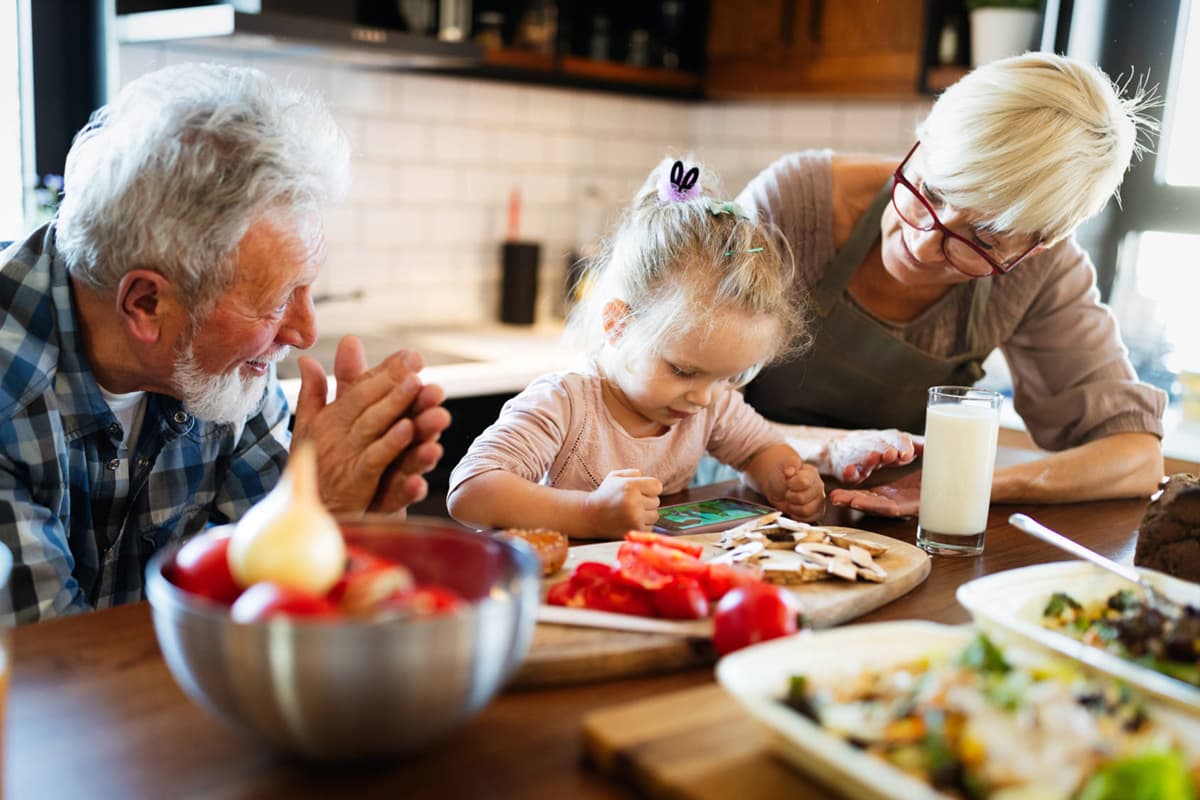Grandparents eating breakfast with grandchild